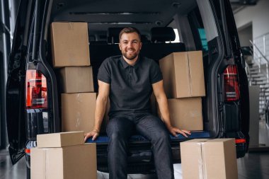 Mola verdim, dinlendim, oturdum. Teslimatçı ya da yükleyici elinde bir kutuyla arabanın yanında..