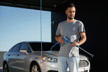 Otomobili yıkamaya hazırım. Adam dışarıda arabasıyla bekliyor..