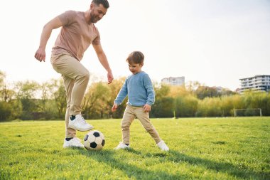 Futbol oynuyordum. Mutlu baba ve oğul yazın sahada eğleniyorlar..