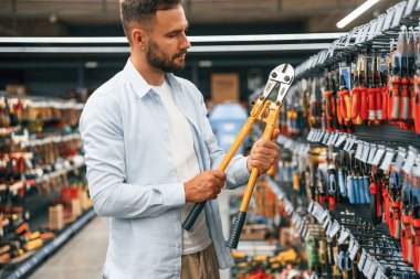 Bahçe makasıyla. Adam hırdavatçıda..