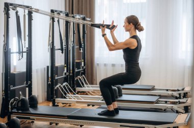 Spor seansı. Genç bayan antrenman malzemeleriyle spor salonunda..