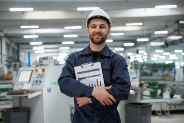 Sonuçlardan memnun, grafikler tutuyor. Fabrika işçisi kasketli bir şekilde içeride..