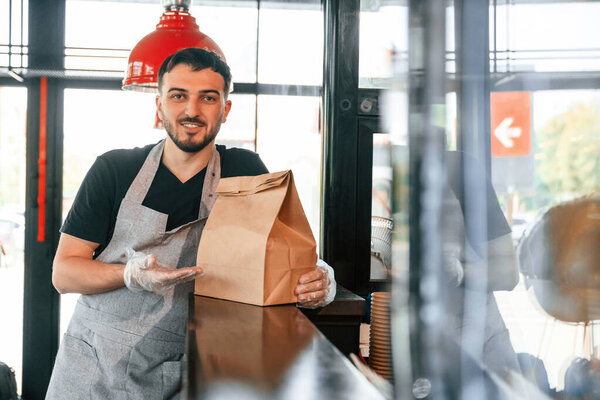 Man is serving delicious street food.