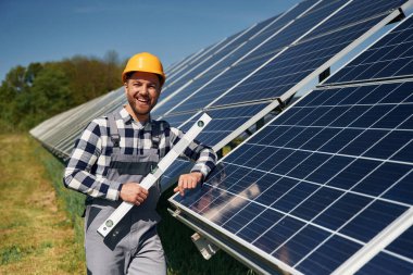 Portre, dengeleyici alet. Gündüz vakti fotovoltaik güneş panelleri olan bir mühendis..