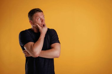 Korkmuş, stresli hissediyorum. Adam stüdyoda arka plana karşı..