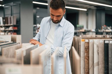 Ev için ürünler. Adam hırdavatçıda..