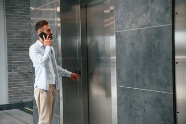 Resmi elbiseli adam içeride, asansörde..