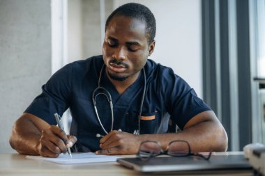 Belgeye bilgi yazılıyor. Profesyonel doktor içeride, ofisinde..