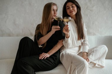 İçkiyle, kutlama yaparak. İki mutlu genç bayan en iyi arkadaş içeride..