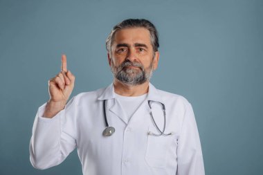 Paltolu profesyonel doktor. Sunbae stüdyoda arka planda bekliyor..