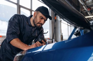İşine odaklan. Tamirci bir araba istasyonunda..