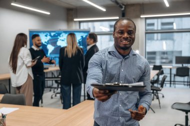 Siyah adam not defteriyle birlikte. Bir grup ofis çalışanı içeride birlikte..