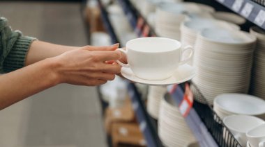 Yeni beyaz fincan. Hırdavatçıdaki kadının yakın görüntüsü..