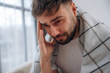 Kötü, kötü bir baş ağrısı. Hasta adam evde kendini kötü hissediyor..