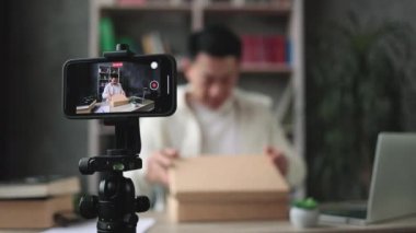 Akıllı telefon ekranına odaklan, yeni kablosuz tabletle kutuları açarken kameraya video kaydet. Erkek nüfuzlu kişi, abonelerle yeni düzen hakkındaki olumlu görüşlerini paylaşıyor..