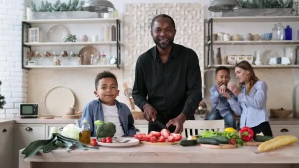 Smukke Afrikanske Far Søn Forbereder Velsmagende Salat Køkkenet Mens Choping – Stock-video
