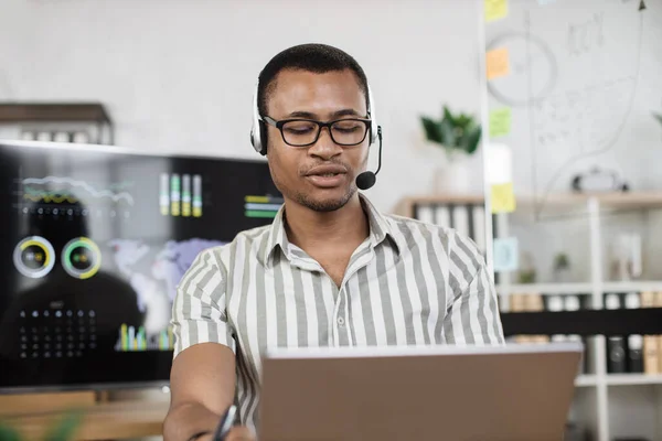 Confident African Man Striped Shirt Using Headset Sitting Modern Office — Photo