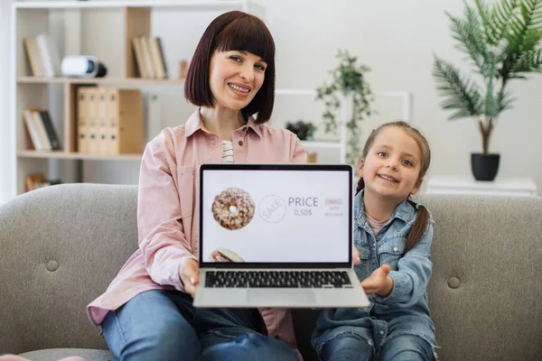 Vrolijke Jonge Dames Zitten Thuis Een Gezellige Bank Tonen Laptop — Stockfoto