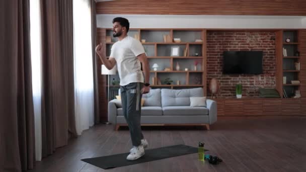 Jóképű Arab Férfi Rövid Ruhában Aktív Fitnesz Gyakorlatokat Végez Nappaliban — Stock videók