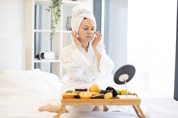 Relaxed Caucasian Female Applying Eye Gold Masks Morning Bath While — Stock Photo, Image