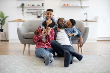 Kot pantolon giymiş enerjik çoklu etnik çocuklar güneşli bir günde evde otururken rahatlamış yetişkinlerle konuşuyorlar. Sevimli kardeşlerim, neşeli ailelere yemekten sonra parkta gezinmeyi soruyorlar..