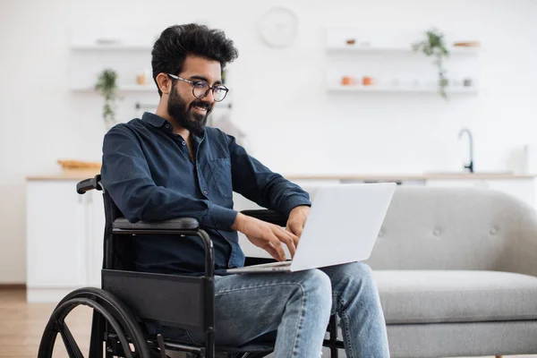 Joyful Indian Man Wheelchair Holding Laptop Knee While Stay Middle — Fotografia de Stock