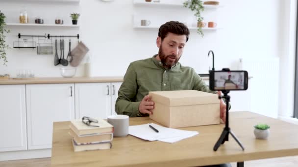 Positive Caucasian Man Filming New Vlog Modern Smartphone While Unpacking — Stock Video