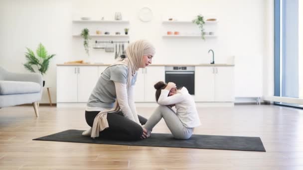 Aktive Muslimische Frau Sportkleidung Fixiert Die Füße Ihrer Töchter Während — Stockvideo