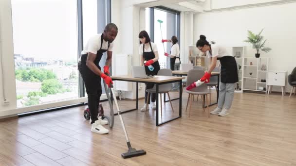 Team Young Multicultural Cleaners Vacuums Floor Wipes Tables Gadgets Shelves — Stock Video