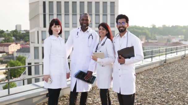 Portrait Successful Team Multinational Doctors White Coats Stethoscopes Holding Gadgets — Stock Video