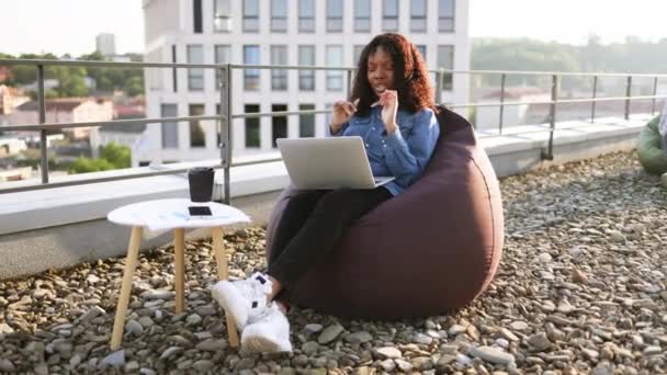 Relaks Afroamerykanka Prowadzi Konferencję Internetową Przez Laptopa Słuchawki Podczas Pobytu — Wideo stockowe