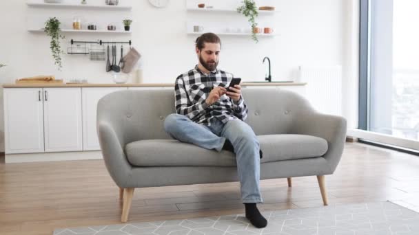 Caucasian Male Checkered Shirt Holding Smartphone While Staying Modern Workplace — Stock Video