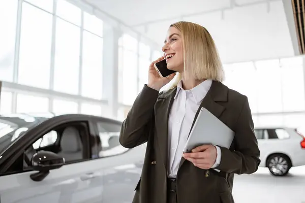 Smiling Saleswoman Smartphone While Having Business Call Car Showroom Car Stock Image