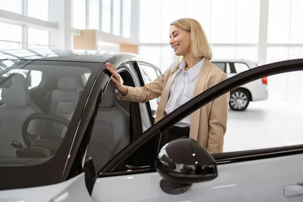 Blond Young Female Choosing Auto Wants Buy New Automobile Car Stock Photo