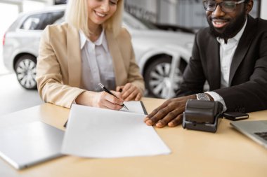 Kadın müşterinin el görüşü, takım elbiseli bir müşteri Afrikalı bir satıcıyla kağıt sözleşme imzalama belgesi otomobili seç, araba galerisi araç galerisi galerisi araba galerisi araba galerisi araba galerisi otomobil mağazasından yeni otomobil al..