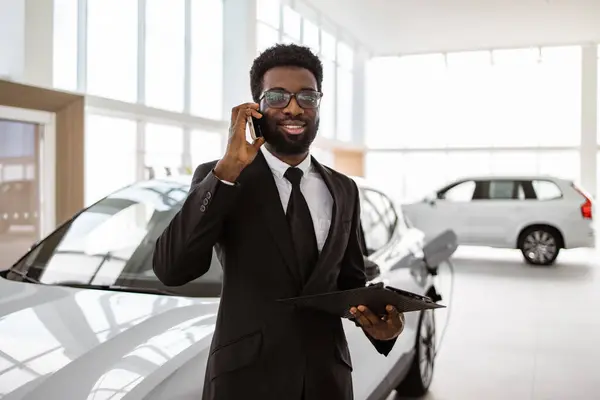 Car Dealer Holding Clipboard Automobile Showroom Smiling Salesman Using Smartphone Royalty Free Stock Images