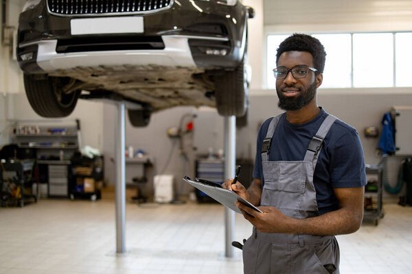 Mechanic Inspecting Car Hydraulic Lift Auto Repair Shop Man Overalls Stock Picture