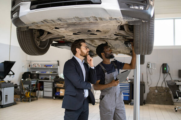 Mechanic Customer Inspecting Car Lift Auto Repair Shop Professional Mechanic Stock Image
