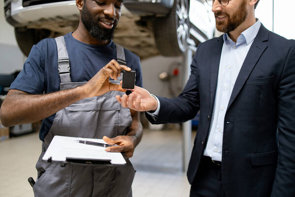 Mechanic Overalls Handing Car Keys Businessman Suit Auto Repair Shop Royalty Free Stock Photos