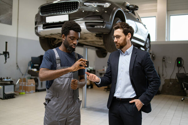 Mechanic Handing Car Keys Businessman Auto Repair Shop Car Lifted Stock Image