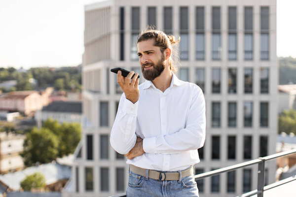 Bearded Man White Shirt Speaking Smartphone While Standing Rooftop City Stock Picture