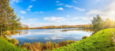 Panoramic view of autumn park on pond in Katowice, Poland clipart