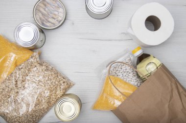 Donations food with canned food on light background background, canned goods and dry food non perishable with cooking oil, donate concept.