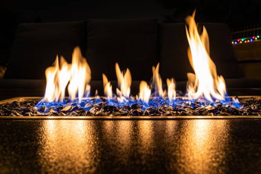 A close-up of the flames in a home fire pit in long exposure. clipart