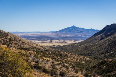 The border between the United States and Mexico as viewed from a distance through a valley.