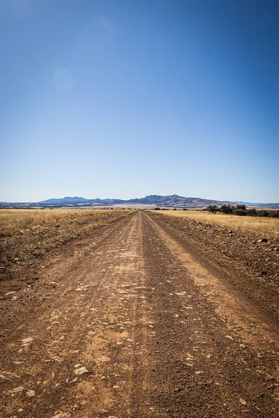 Dirt Road Leading Distance Mountains Horizon Clear Blue Sky — Stockfoto