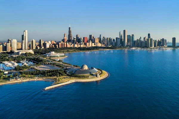 前景にアドラープラネタリウムとシェッド水族館とモンロー港の空中ビューとその先のシカゴのダウンタウンのスカイライン ストック写真