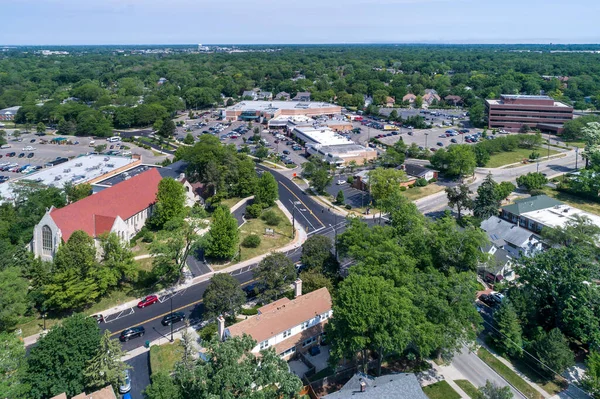 Aerial view of a business district with stores, a church and shopping center in downtown Northbrook, IL.