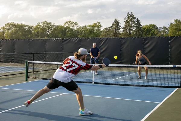 Male Pickleball Player Returns Shot His Opponents Who Approaching Net Stock Photo