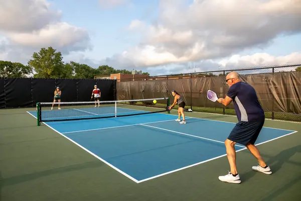 Male Pickleball Player Hits Return His Opponents His Partner Watches Stock Photo